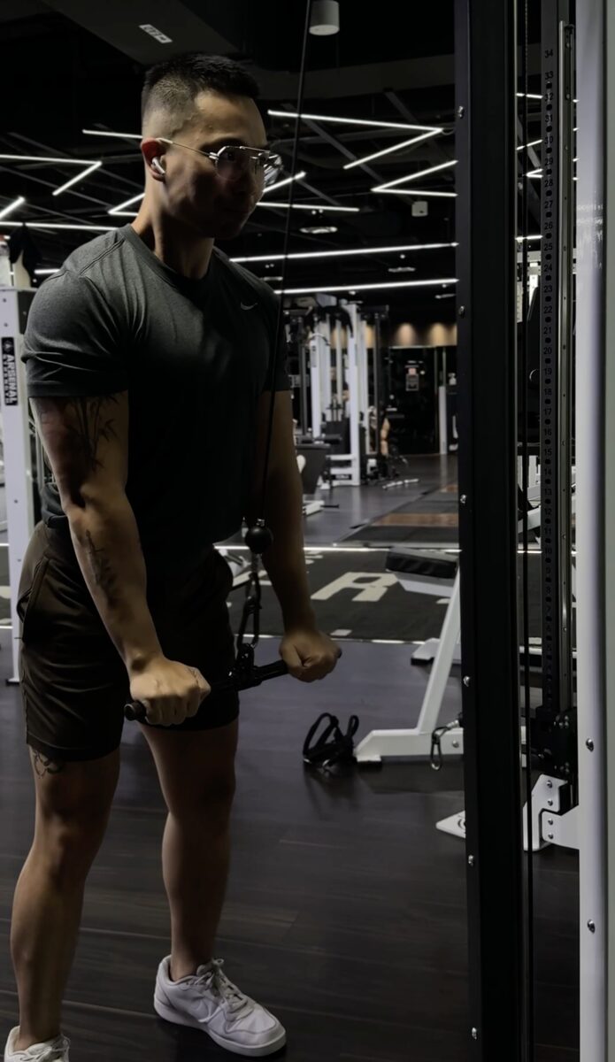 Coaching precision on cable exercises at Freedom Gym